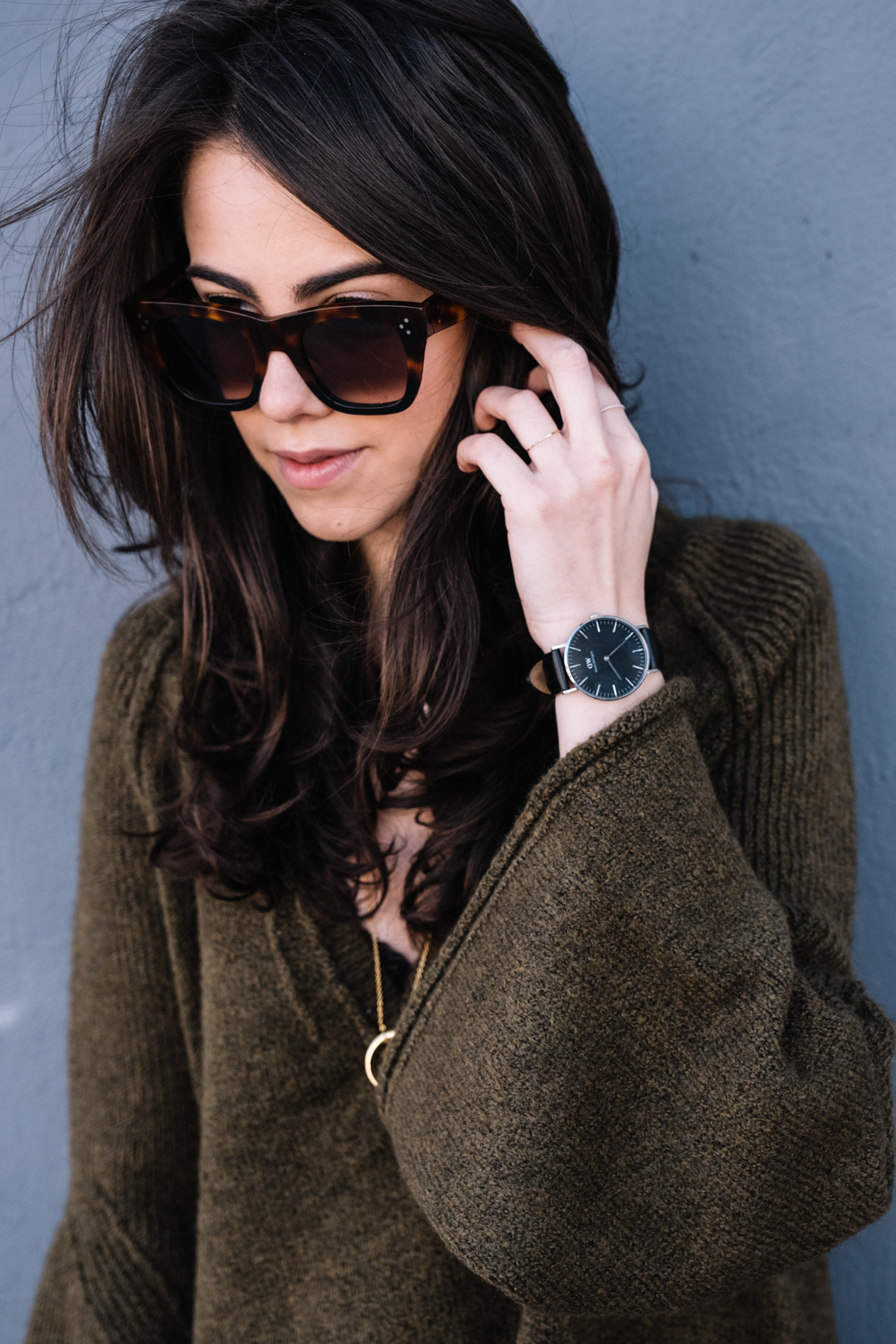 Jackie Roque styling a free people bell sleeve sweater, celine sunglasses, daniel wellington and a gorjana necklace.