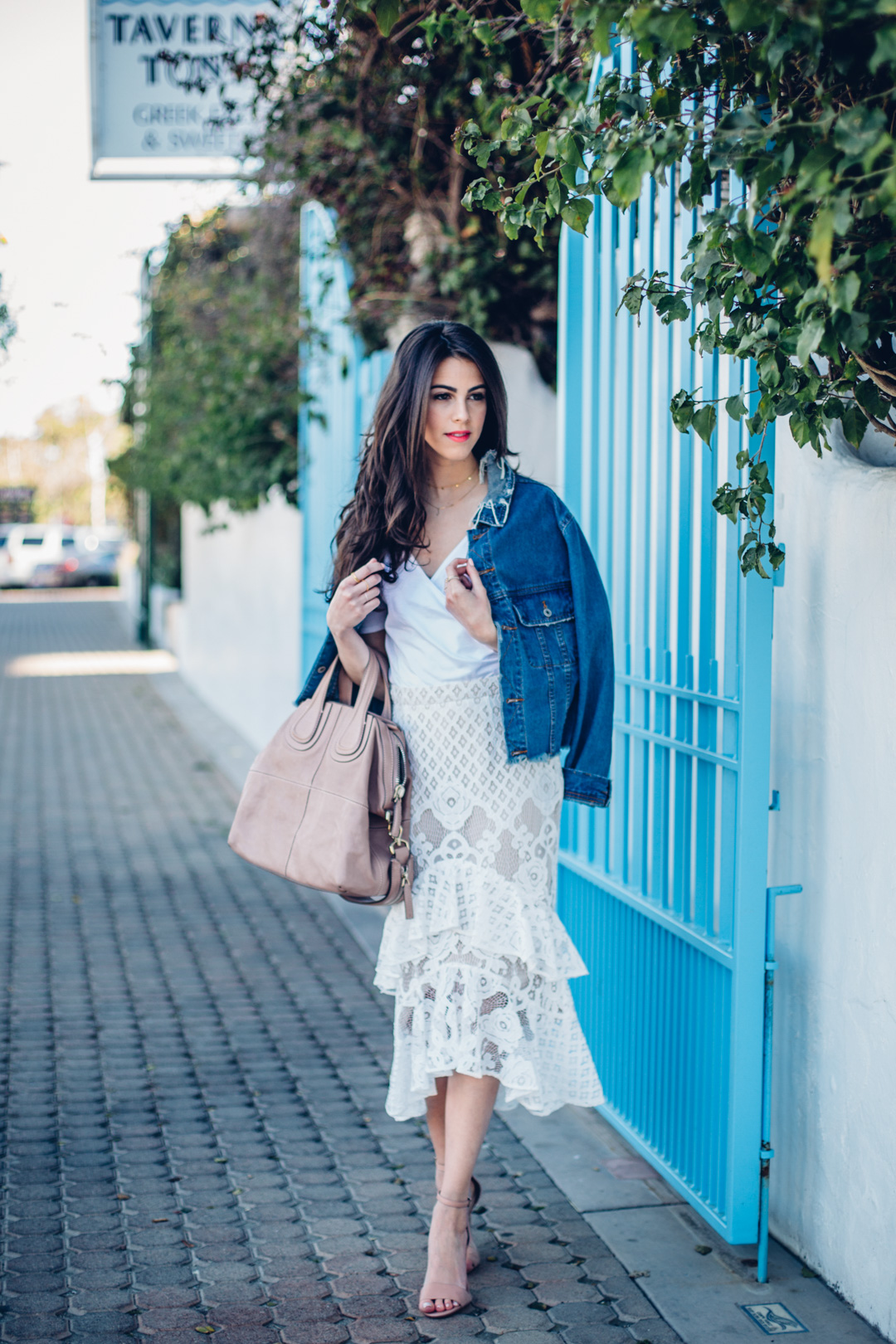 Jackie Roque styling a spring look in Malibu, wearing Trouve Surplice Cold Shoulder Bodysuit and a Market Miami denim jacket.