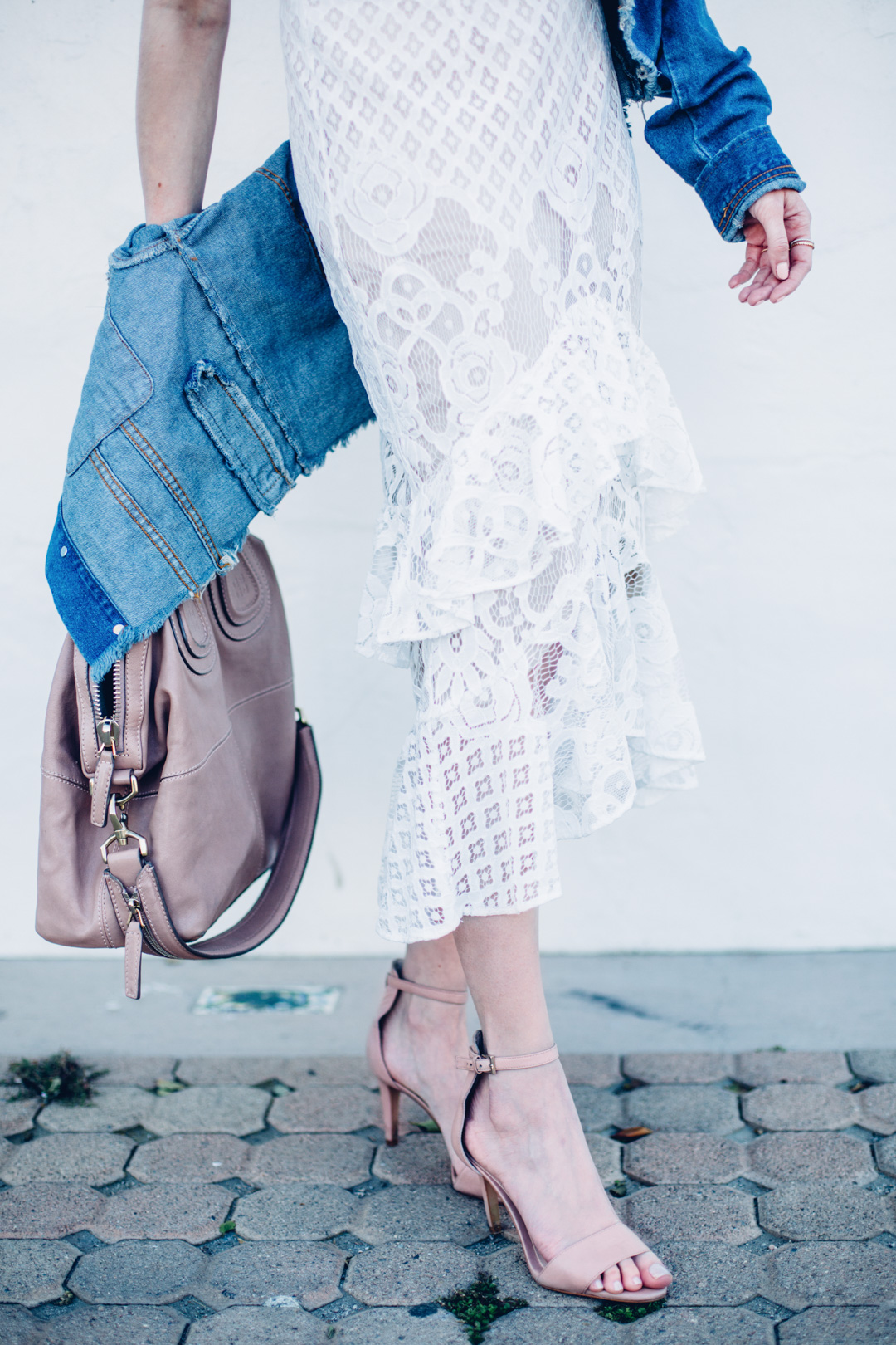 Jackie Roque styling a spring look in Malibu, wearing a Trouve Tiered Lace Midi Skirt, Trouve Surplice Cold Shoulder Bodysuit and a Market Miami denim jacket.
