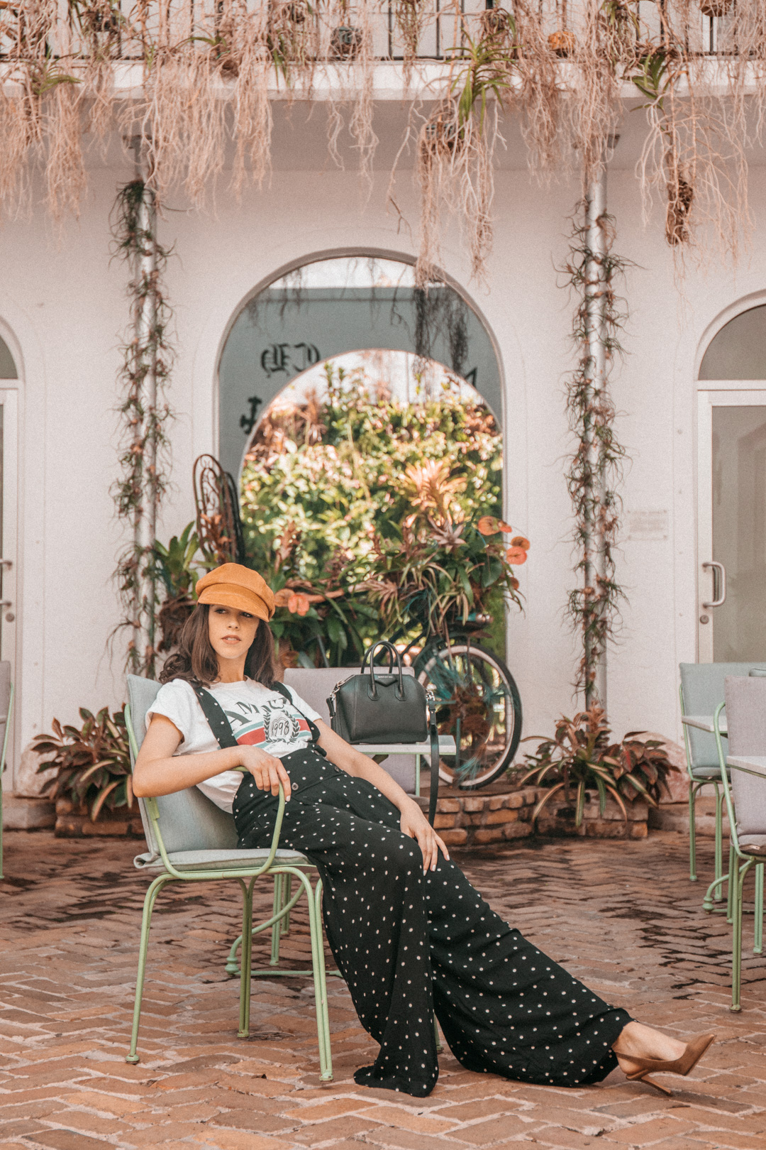 Jackie Roque styling a Free People jumpsuit, Topshop Amour Tee, Givenchy Antigona Bag and a European hat in Miami.