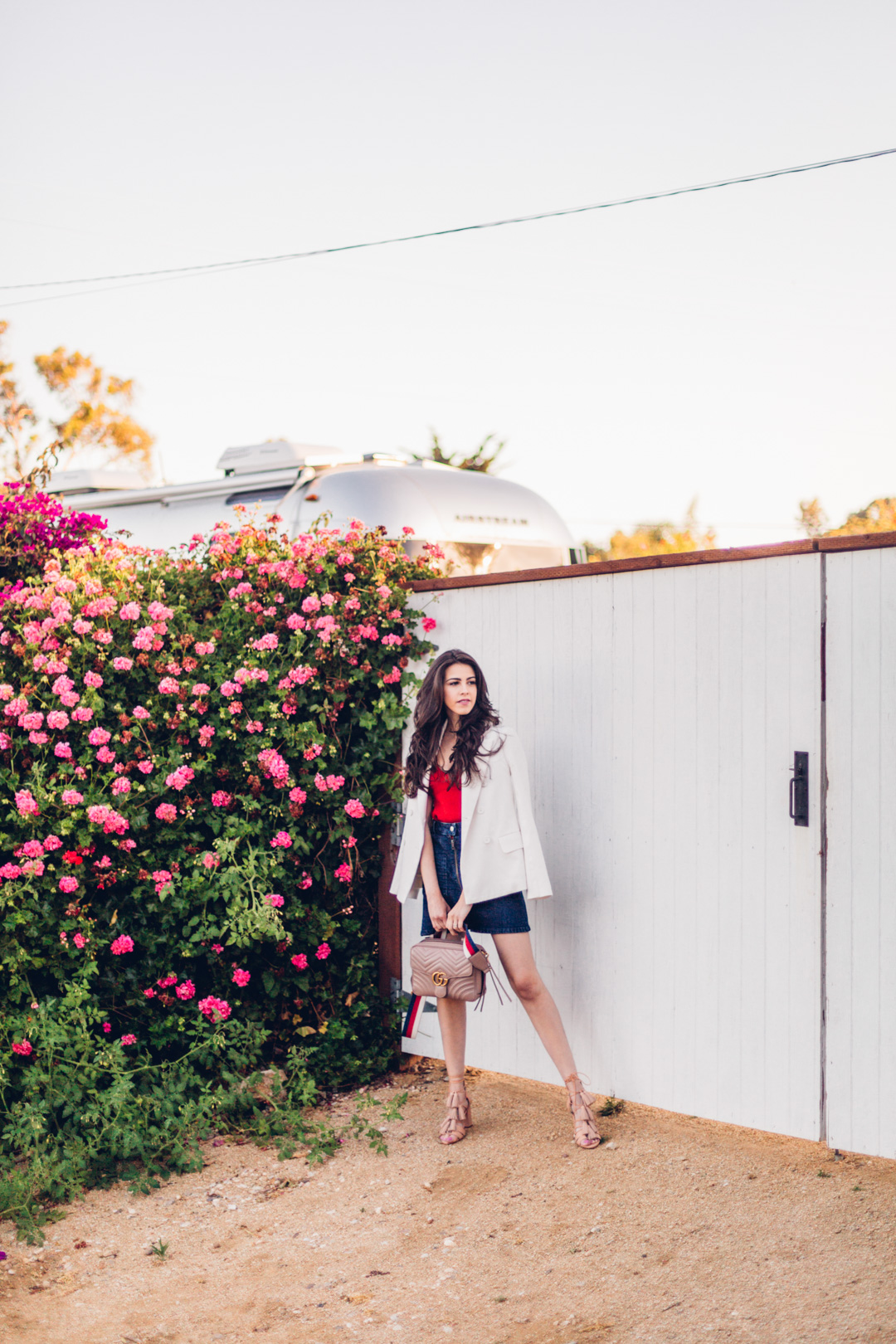 Jackie Roque styling a red, white and blue outfit with the Gucci GG Marmont Shoulder Bag in Malibu, california.