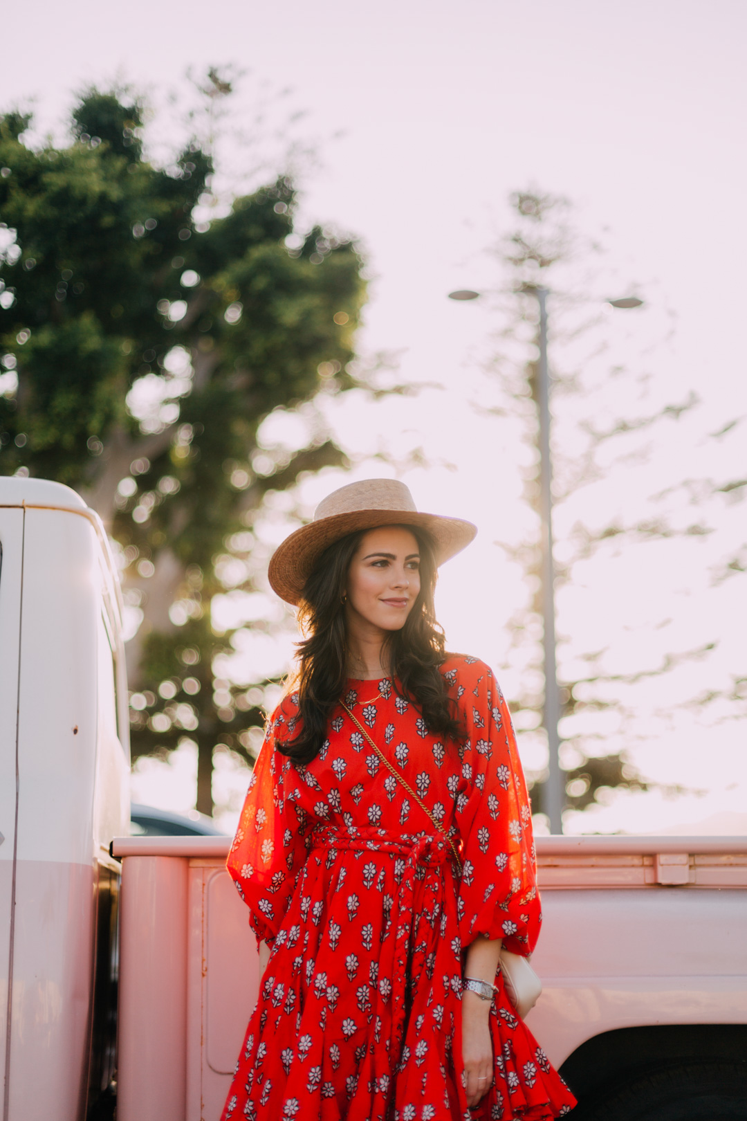 Jackie Roque Salas styling a Rhode Ella Dress, Lack of Color Hat, and Sam Edelman boots in Malibu, california.