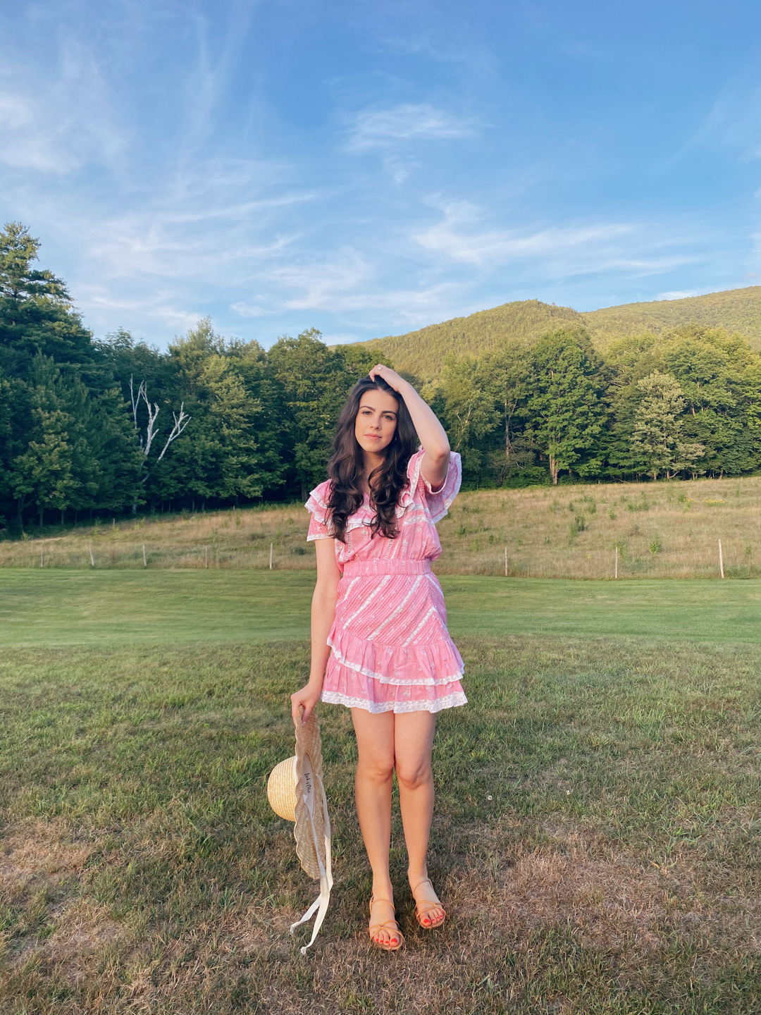 Jackie Roque Salas styling a LoveShackFancy dress and Lack of Color Hat in Vermont.
